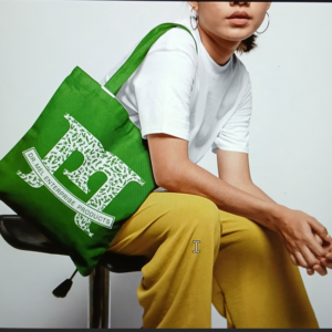 The medium gray long sleeve shirt with person sitting in yellow pants, white shirt, with green Bag
