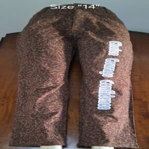 A Pair of Brown and Black Pants with  White Personal Logo words going down right leg that say (Choice Courage Confidence ) going down the right Pants leg