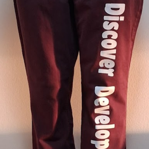 A Pair of straight legs Maroon pants with White Personal  Logo words that say (Discover  Develop  Deploy) down right Pants leg